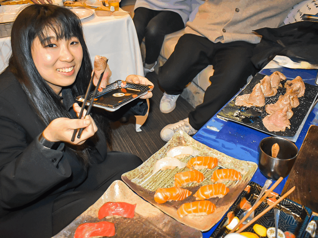 寿司職人のお寿司を食べえる女性